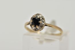 A 9CT GOLD SAPPHIRE AND DIAMOND CLUSTER RING, raised cluster, centring on a claw set, oval cut