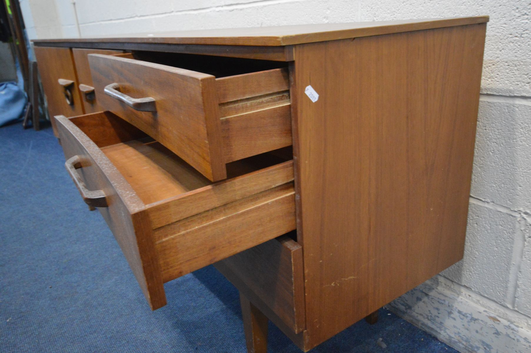 A TEAK 6FT CONCAVE SIDEBOARD, a bank of three drawers, the top drawer with a green baize lined - Image 3 of 4