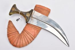 AN ARABIC JAMBIYA DAGGER AND SCABBARD, fitted with a carved animal horn handle, set with brass