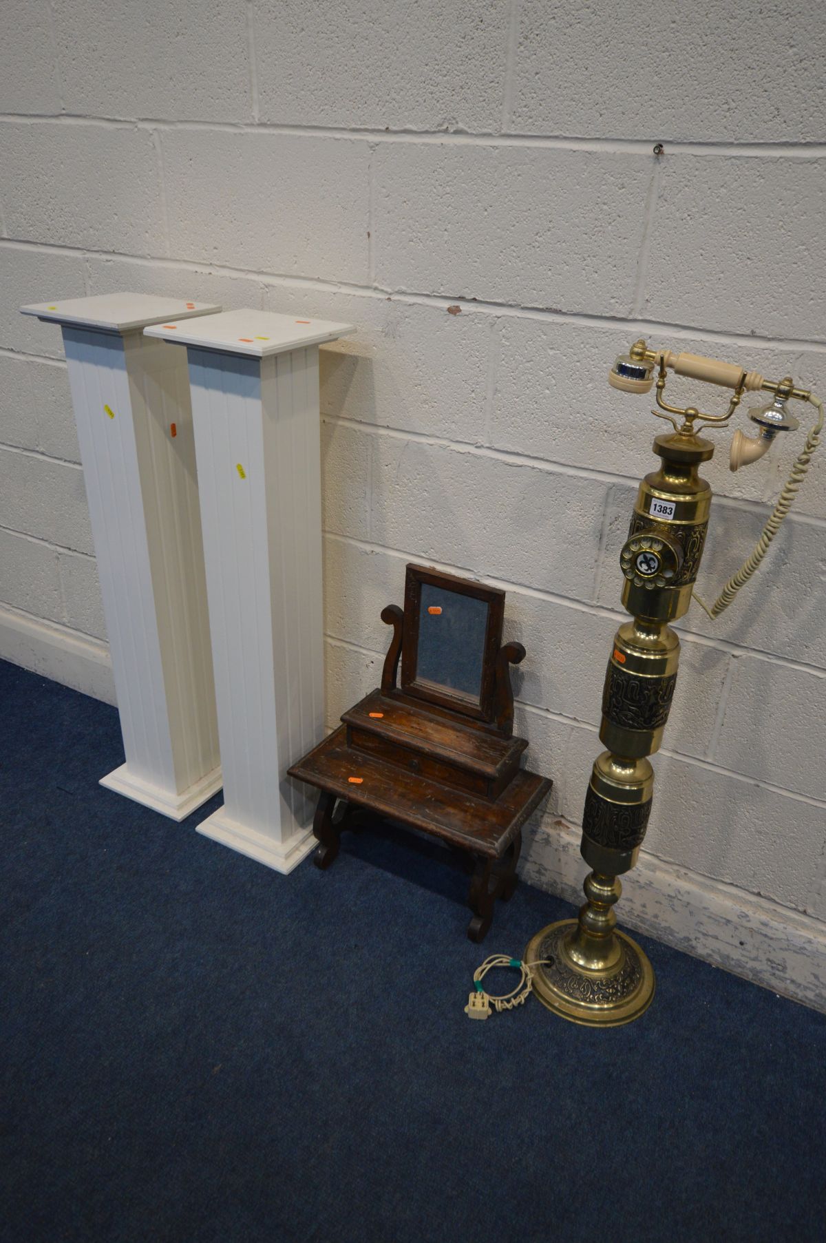A VINTAGE BRASS FLOORSTANDING DIAL PHONE, height 106cm together with a dressing table mirror and a