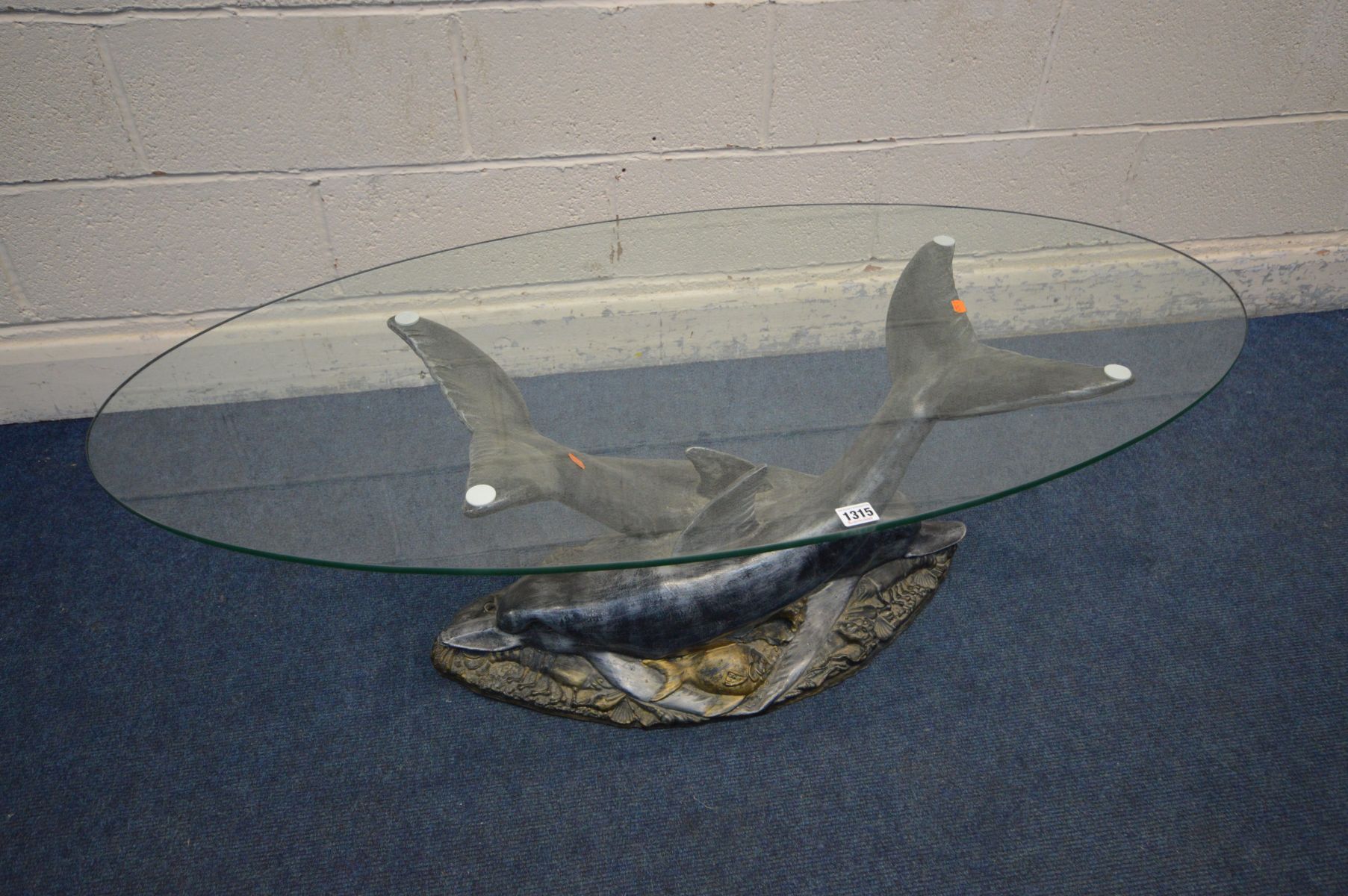 AN OVAL GLASS TOP COFFEE TABLE SUPPORTED ON TWO RESIN DOLPHINS lying on a sea bed, width 120cm x - Image 2 of 3
