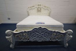A LATE 20TH CENTURY CREAM PAINTED CONTINENTAL 4FT6 BEDSTEAD, with heavy ornate carved decoration,