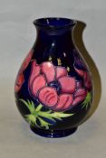 A MOORCROFT POTTERY VASE, 'Anemone' pattern on blue ground, impressed backstamp and painted WM to