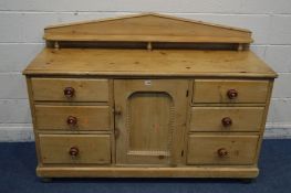 A VICTORIAN PINE SIDEBOARD with a raised back and shelf, above two banks of three drawers flanking a