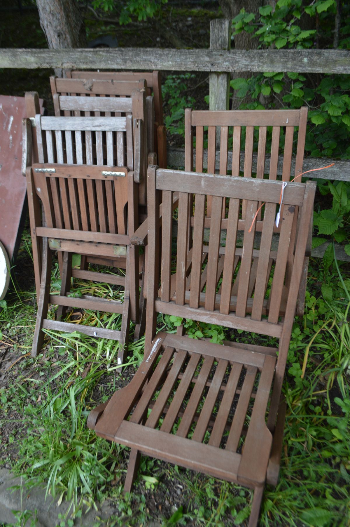 A SET OF SIX STAINED TEAK FOLDING GARDEN CHAIRS, including two armchairs, labelled FSC