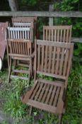 A SET OF SIX STAINED TEAK FOLDING GARDEN CHAIRS, including two armchairs, labelled FSC