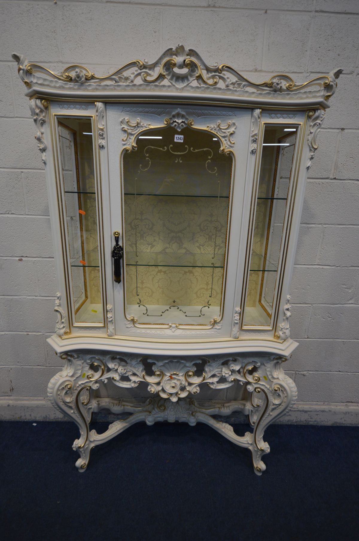 A SILIK BAROQUE ITALIAN DISPLAY CABINET, single door enclosing two shelves, on four shaped legs