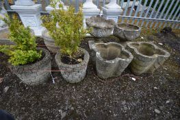 A PAIR OF COMPOSITE CLOVER LEAF GARDEN PLANTERS, along with a pair of brick effect circular planters