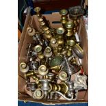 A BOX OF METALWARES, including brass, plated, wooden and chrome candlesticks, candelabrum, a brass