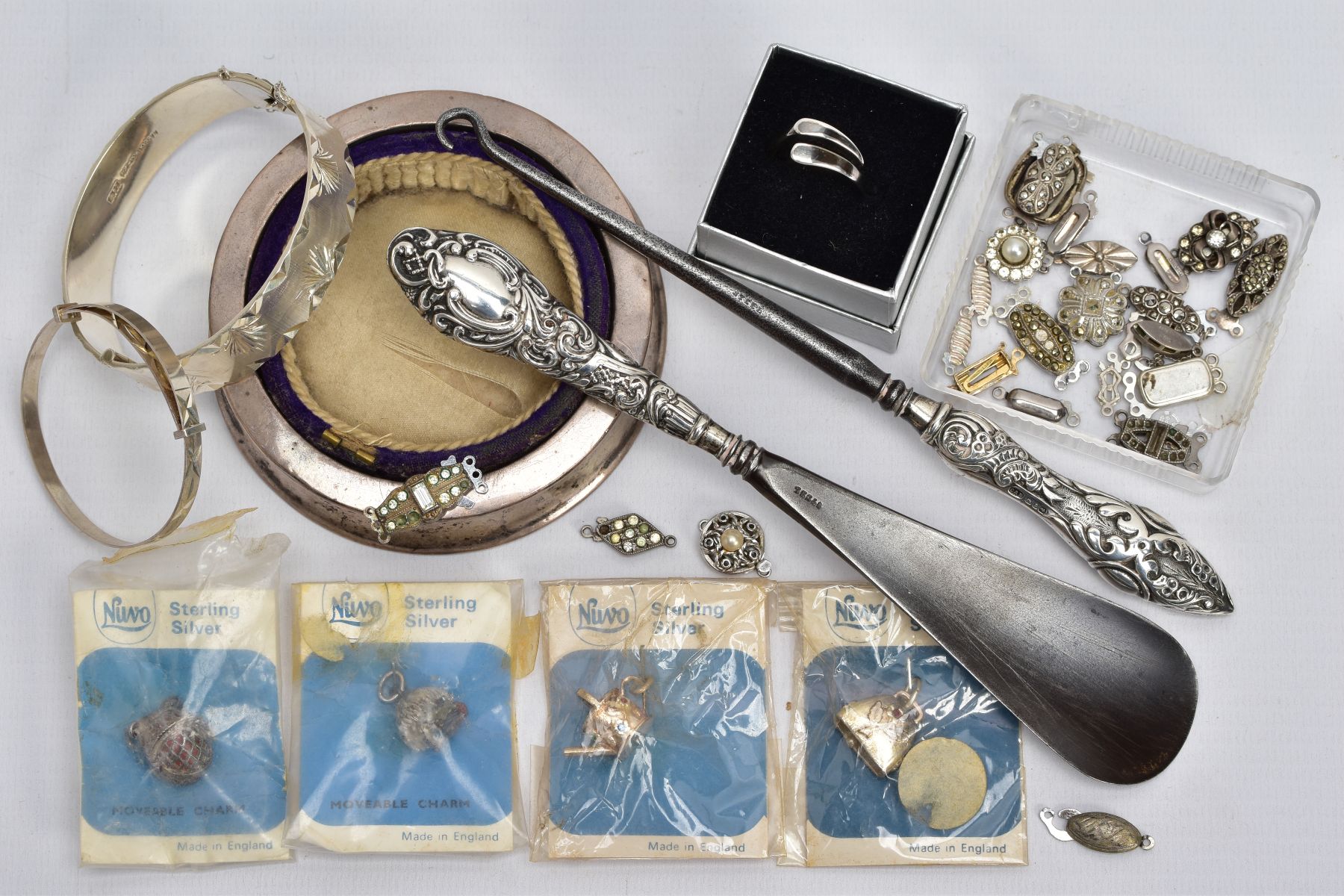 A SELECTION OF SILVER AND WHITE METAL ITEMS, to include four 'Nuvo' sterling silver charms in