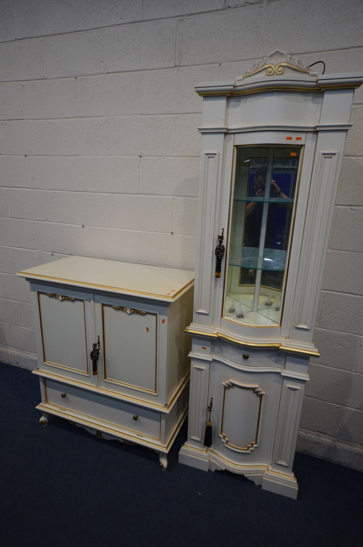 A FRENCH STYLE CORNER CUPBOARD with a bowfront glazed door enclosing two fixed glass shelves,