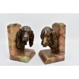 A PAIR OF EARLY 20TH CENTURY FRENCH ALABASTER BOOKENDS mounted with a bronzed springer spaniel on