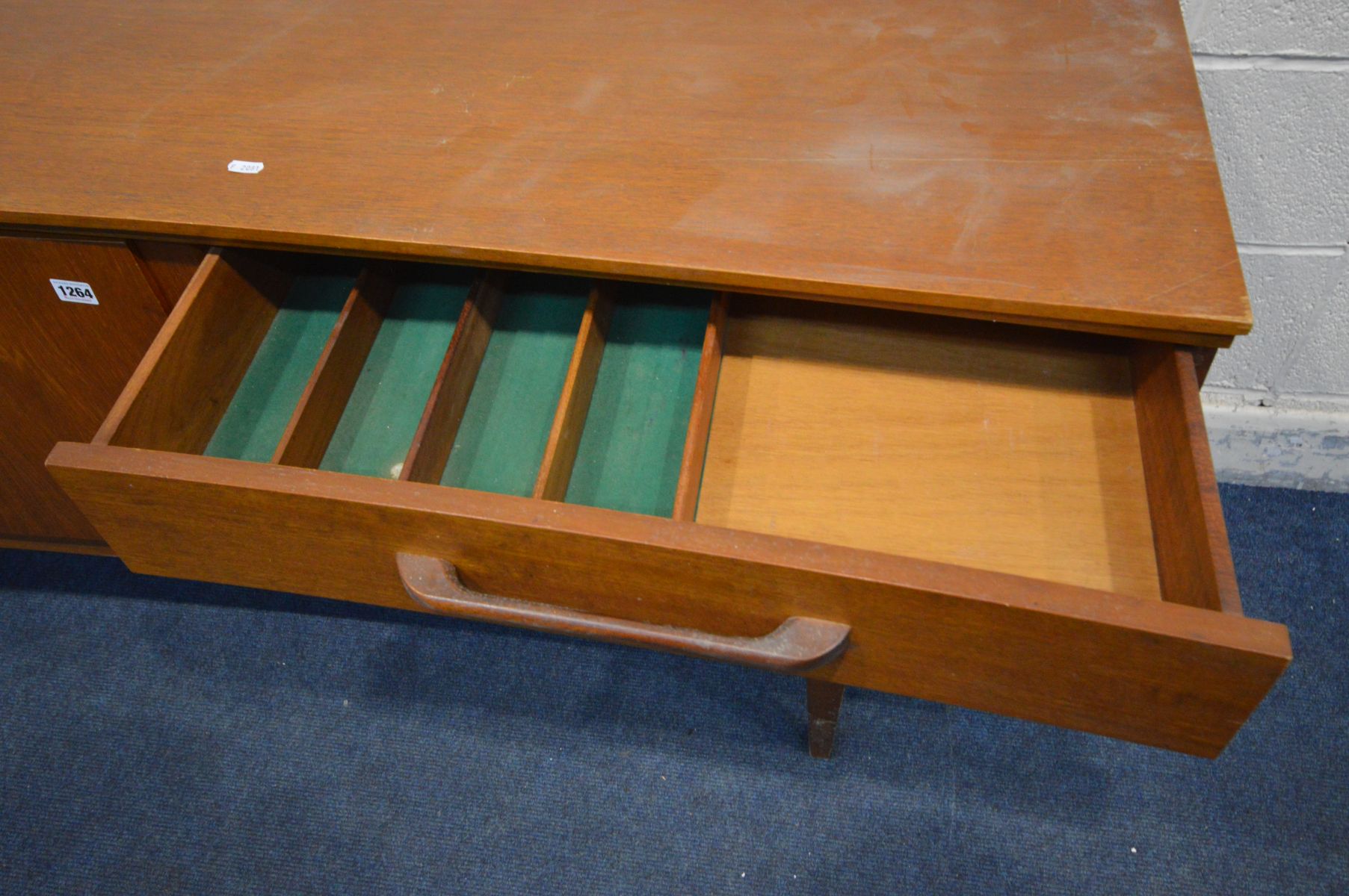 A TEAK 6FT CONCAVE SIDEBOARD, a bank of three drawers, the top drawer with a green baize lined - Image 2 of 4