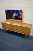 A MEREDEW TEAK DRESSING TABLE with a single mirror and six various drawers, on twin legs, width