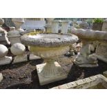 A COMPOSITE GARDEN CAMPANA URN, on a separate base, stamped Sandford stone, diameter 61cm x height