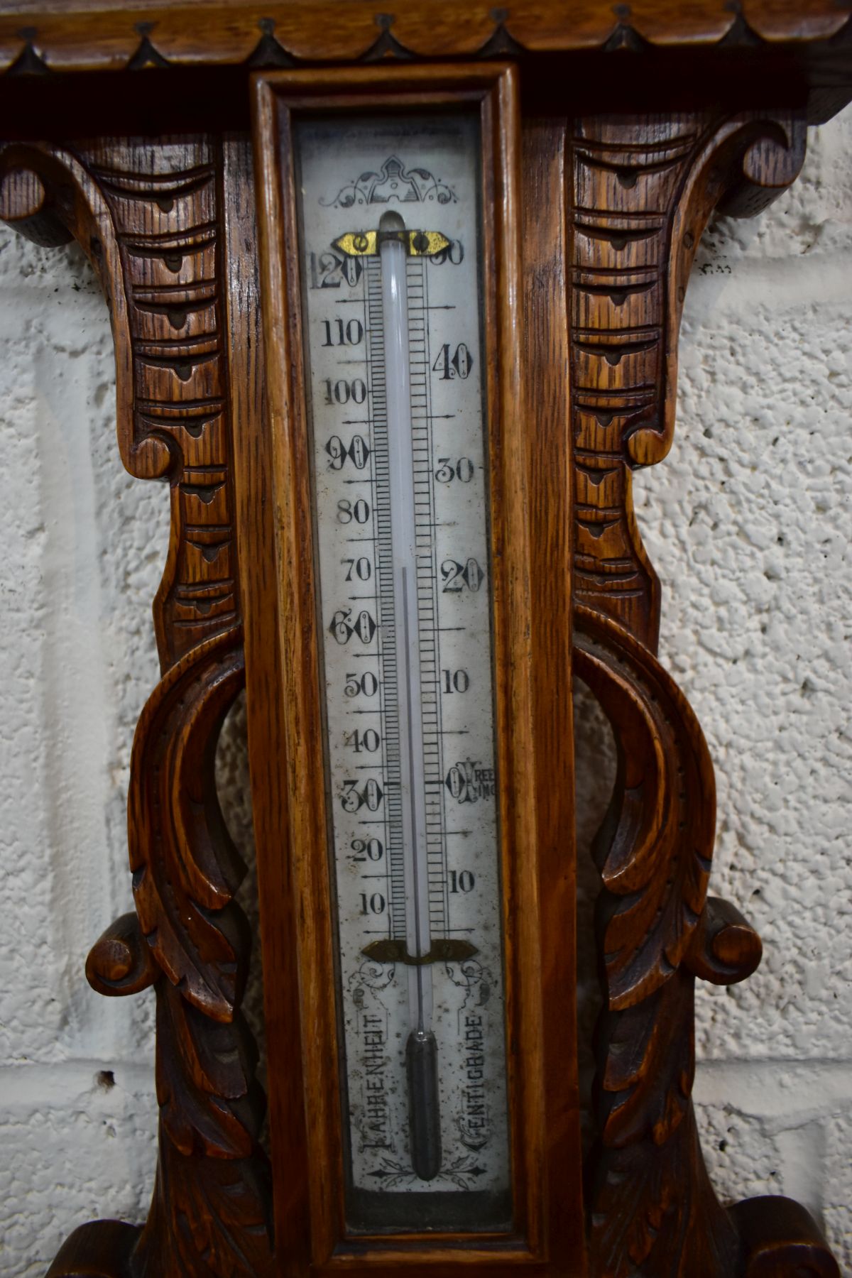 A LATE VICTORIAN CARVED OAK ANEROID BAROMETER, with mercury thermometer and working blued indicator, - Image 3 of 3