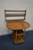 AN ERCOL MODEL 505 ELM AND BEECH DROP LEAF THREE TIER TEA TROLLEY, on orbit casters, open width 96cm