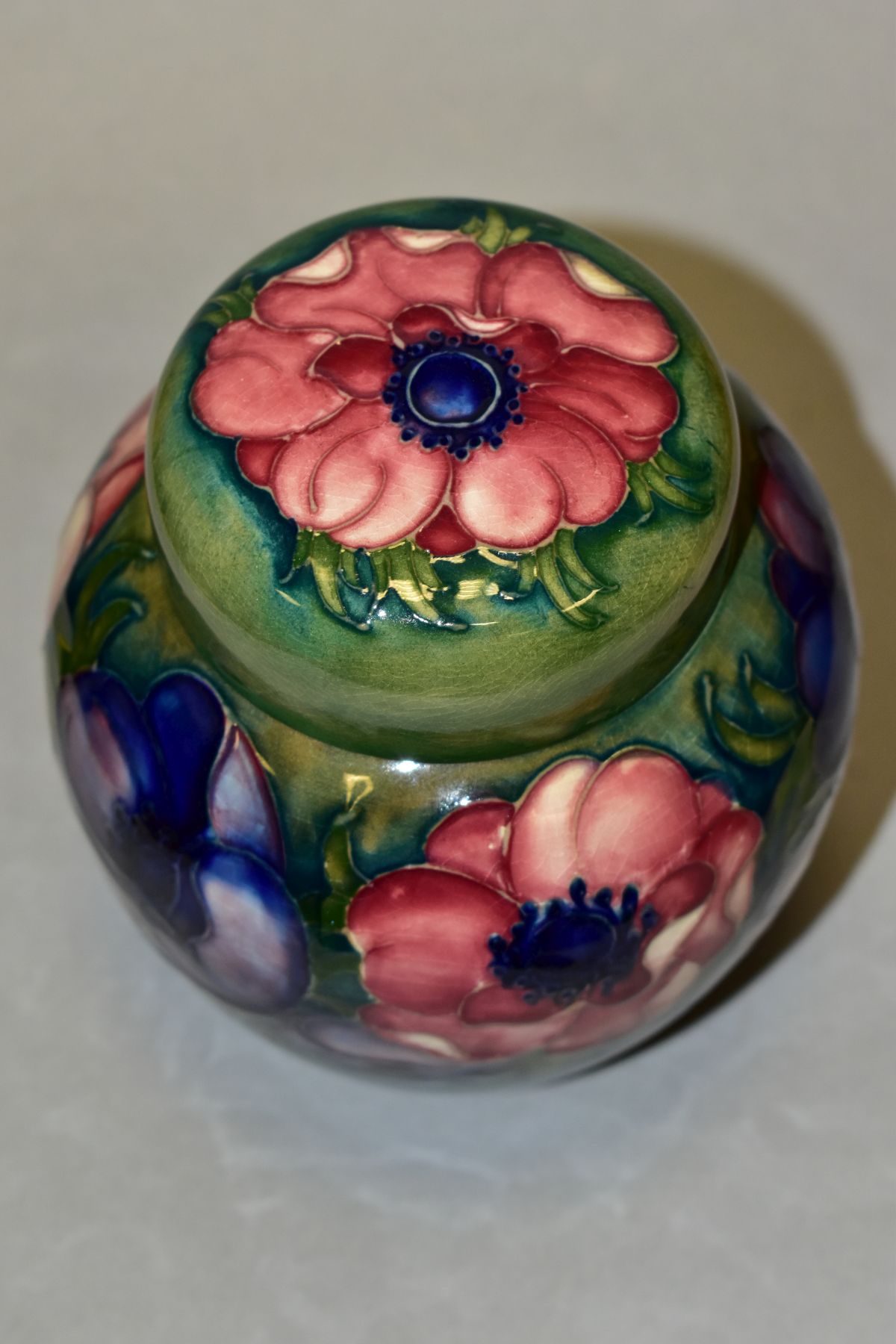 A MOORCROFT POTTERY GINGER JAR AND COVER, decorated in pink/blue anemone on a green ground, - Image 4 of 6