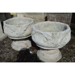 A PAIR OF COMPOSITE FOLIATE GARDEN URNS, on separate bases, diameter 43cm x height 41cm