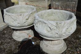 A PAIR OF COMPOSITE FOLIATE GARDEN URNS, on separate bases, diameter 43cm x height 41cm
