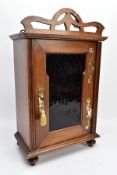 AN OAK ART NOUVEAU ARTS AND CRAFTS STYLE WALL/TABLE TOP CABINET, with brass mounts, green glass