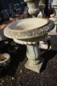 A COMPOSITE GARDEN CAMPANA URN, on a matched pillar support, diameter 65cm x height 86cm