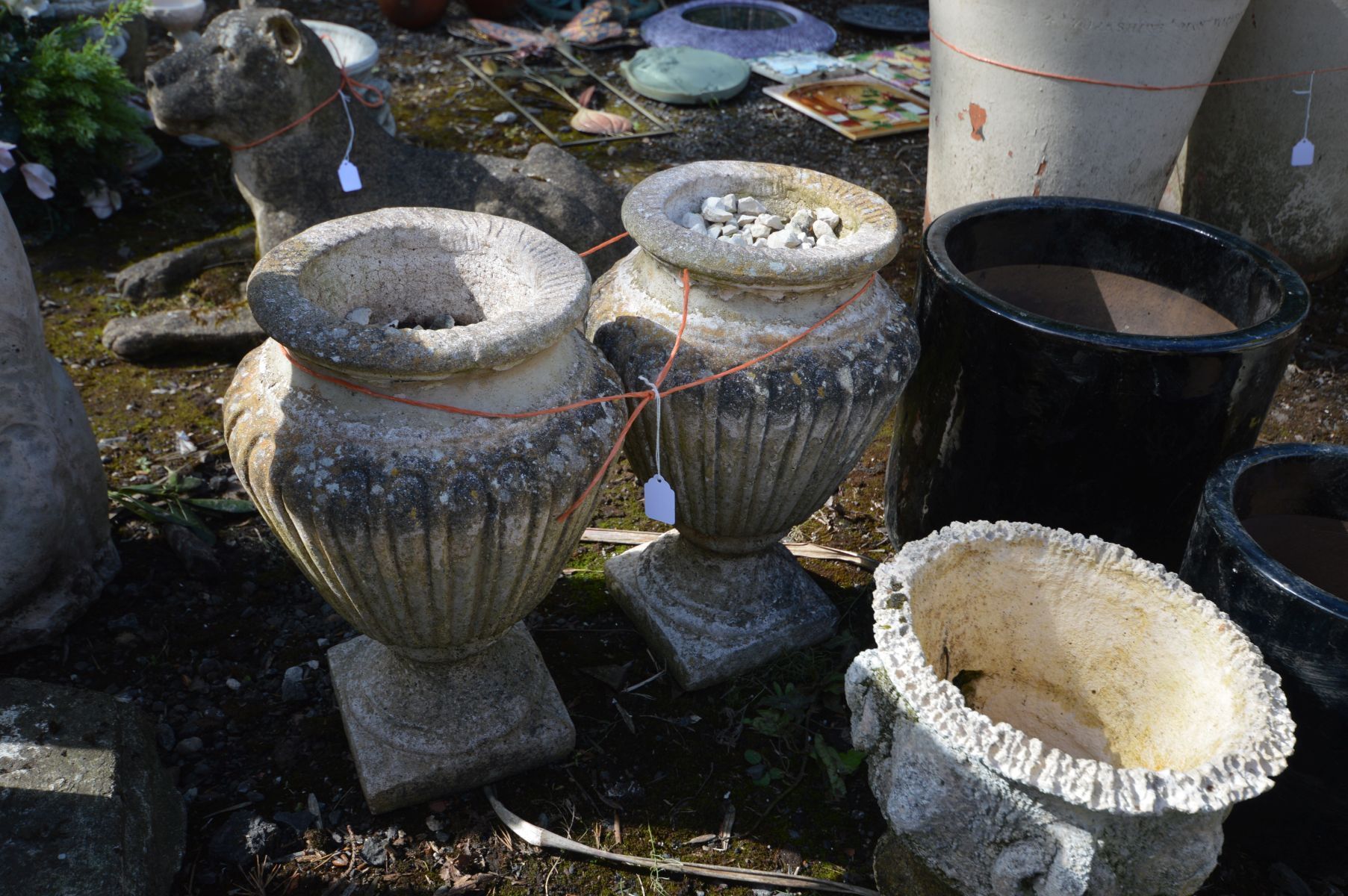 A PAIR OF COMPOSITE URNS, height 42cm, along with two black glazed graduated plant pots, a small urn - Image 2 of 2