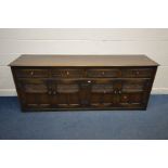 AN EARLY 20TH CENTURY OAK SIDEBOARD, four drawers above four cupboard drawers enclosing fixed