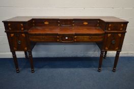 A GEORGE IV MAHOGANY AND INLAID SIDEBOARD, with seven assorted drawers, on six tulip and fluted