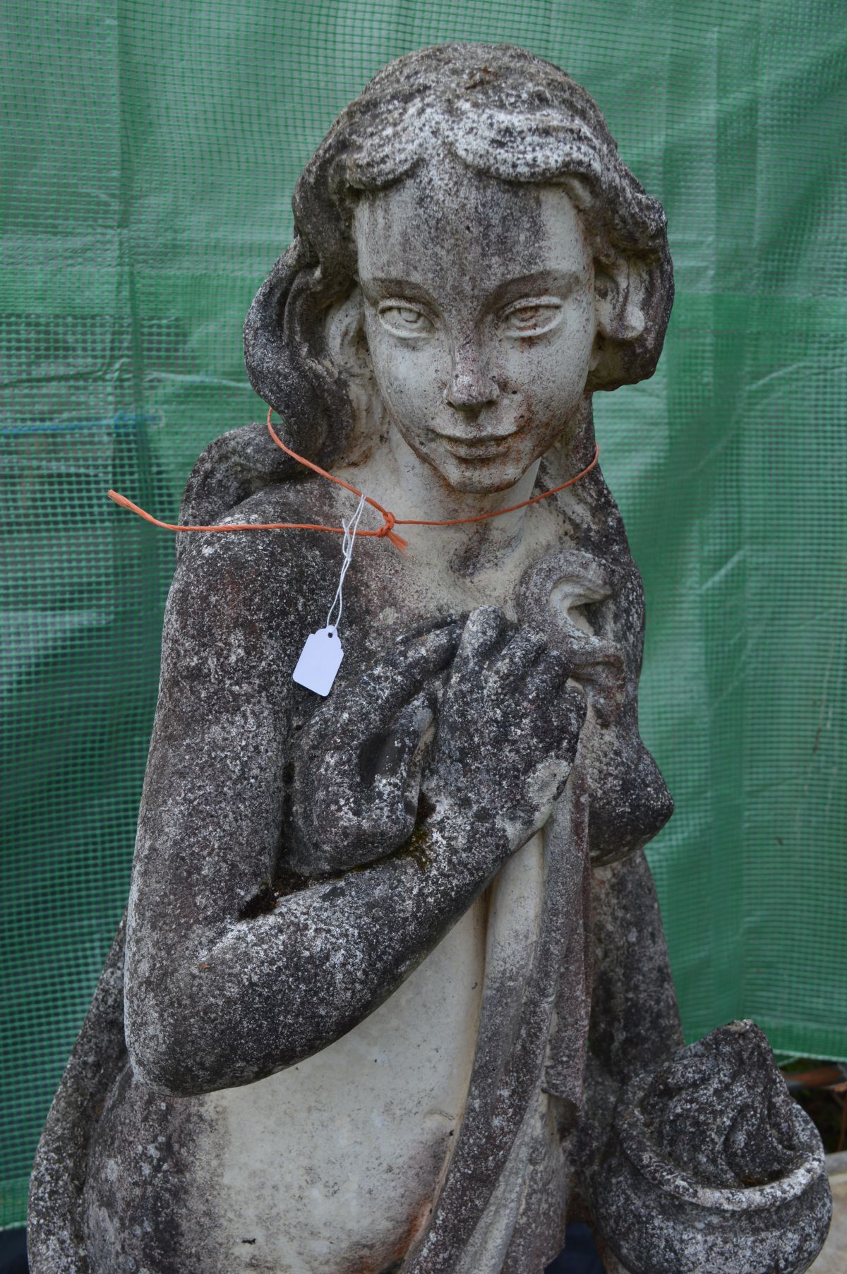 A LARGE WEATHERED COMPOSITE GARDEN STATUE of a semi clad lady in flowing robes, holding a bowl, on a - Image 2 of 4