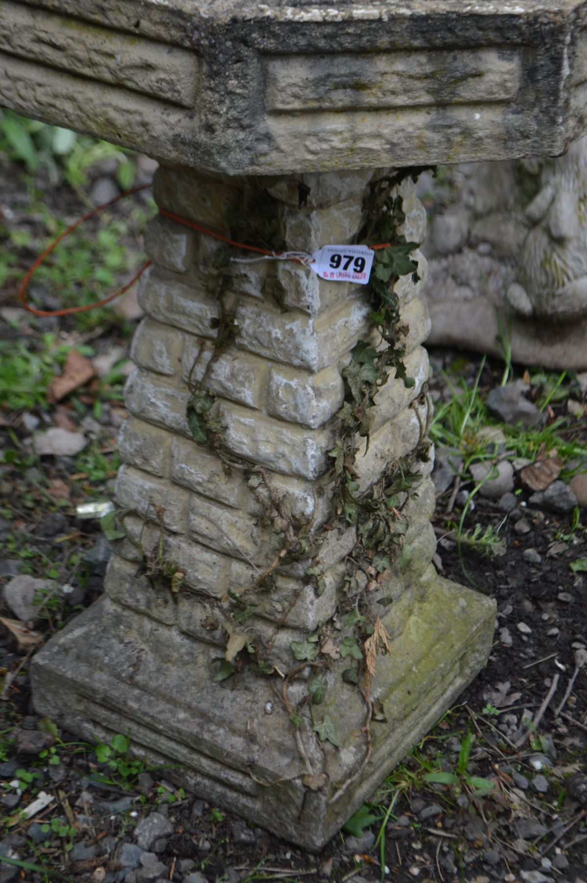 A COMPOSITE OCTAGONAL BRICK EFFECT BIRD BATH, on a separate base, diameter 43cm x height 61cm (crack - Image 2 of 2