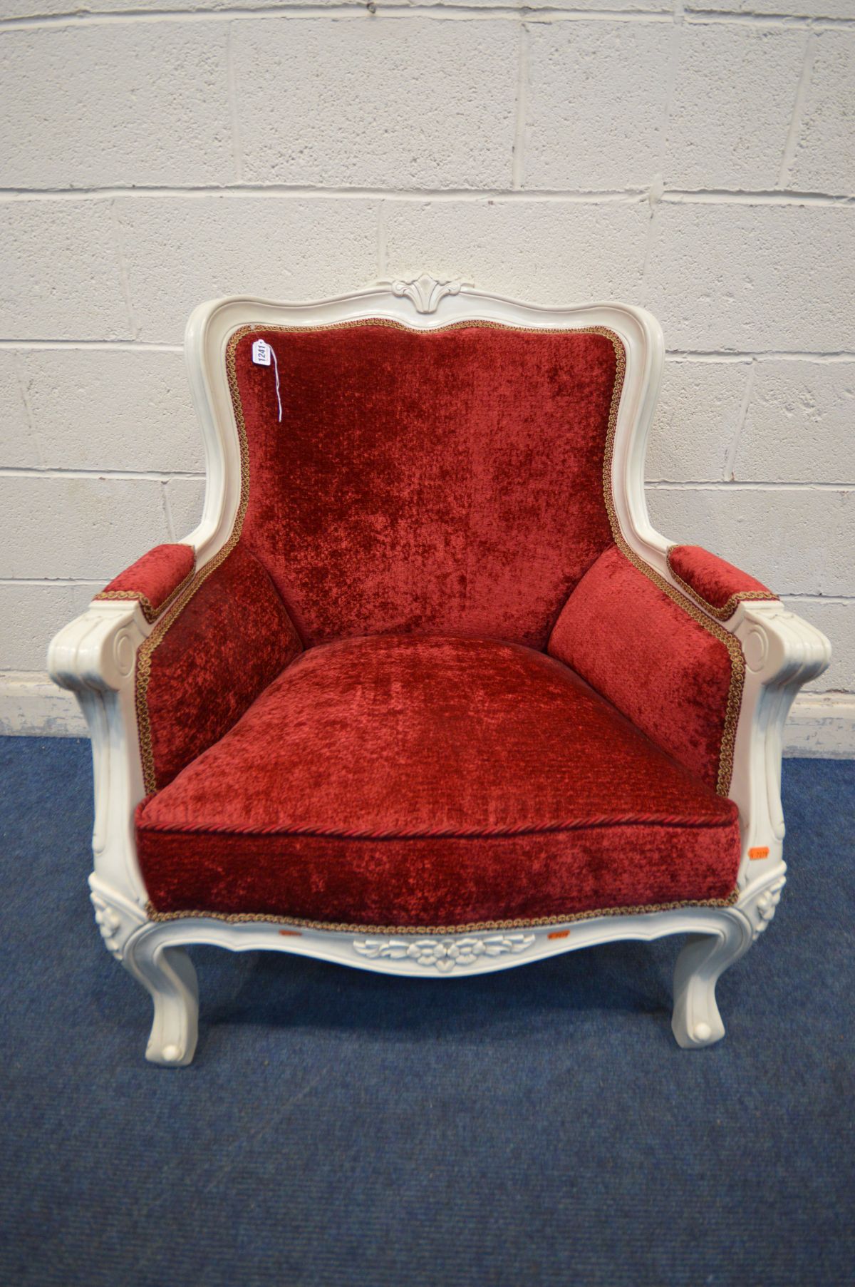 A VICTORIAN STYLE ARM CHAIR, with red upholstery and white painted frame, width 73cm x inner width