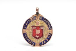 A 9CT GOLD ENAMELLED FOB PENDANT, of a circular form, blue and red enamel inscribed 'Stafford &