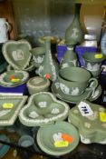 A GROUP OF GREEN WEDGWOOD JASPERWARE, including vases, trinket pots and covers, trinket dishes, a