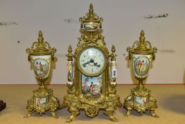 A 20TH CENTURY BRASS AND PORCELAIN CLOCK GARNITURE, the porcelain panels transfer printed with