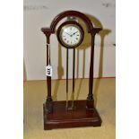 AN EARLY 20TH CENTURY PORTICO MYSTERY CLOCK, the mahogany archway frame with central brass