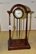 AN EARLY 20TH CENTURY PORTICO MYSTERY CLOCK, the mahogany archway frame with central brass