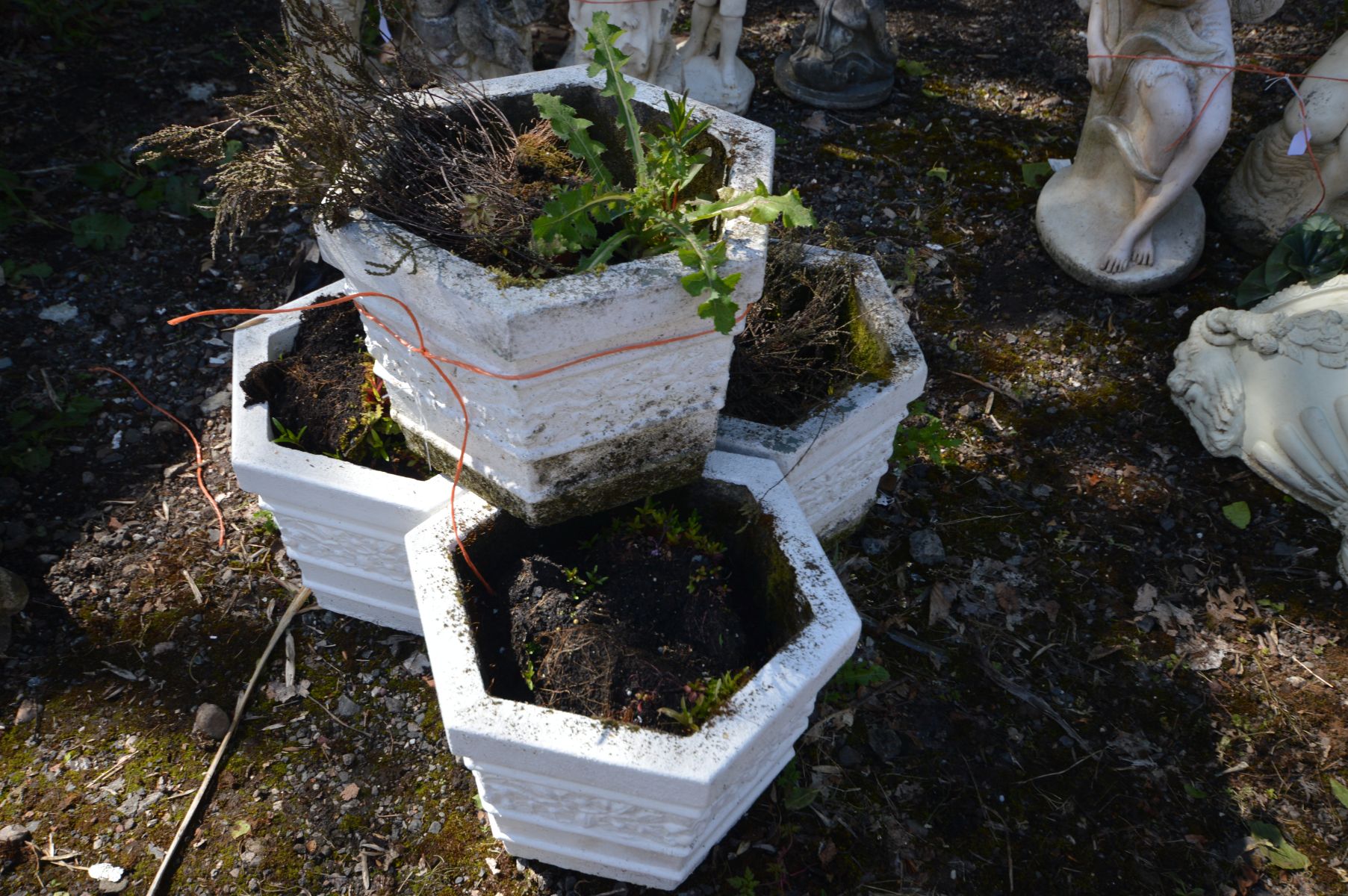 A SET OF FOUR COMPOSITE HEXAGONAL PLANTERS, later painted white, diameter 33cm x height 26cm