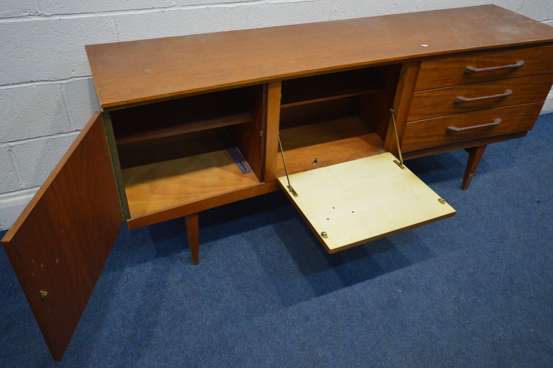 A TEAK 6FT CONCAVE SIDEBOARD, a bank of three drawers, the top drawer with a green baize lined - Image 4 of 4