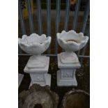 A PAIR OF COMPOSITE ACANTHUS GARDEN URNS, later painted white, on a separate plinth, diameter 43cm x