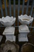 A PAIR OF COMPOSITE ACANTHUS GARDEN URNS, later painted white, on a separate plinth, diameter 43cm x