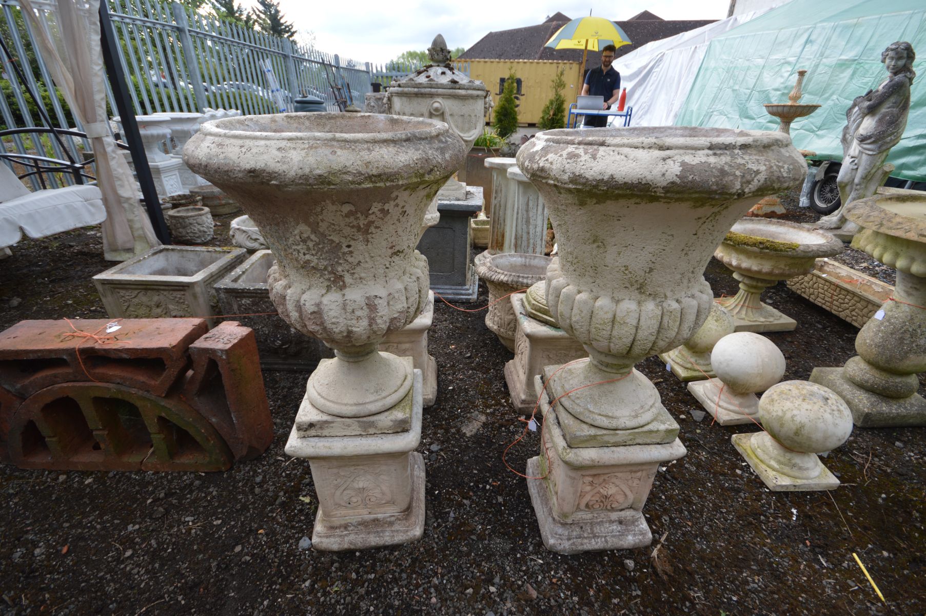 A PAIR OF LARGE COMPOSITE CAMPANA URNS, on separate matched plinths with Art Nouveau decoration,