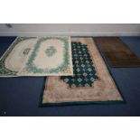 A LARGE GREEN CHINESE WOOLEN RUG, 240cm x 150cm, two similar cream and green ground rugs, both 180cm