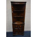 AN OAK REPRODUCTION GEORGIAN STYLE OPEN CORNER CUPBOARD, with two shaped shelves above a multi
