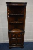 AN OAK REPRODUCTION GEORGIAN STYLE OPEN CORNER CUPBOARD, with two shaped shelves above a multi