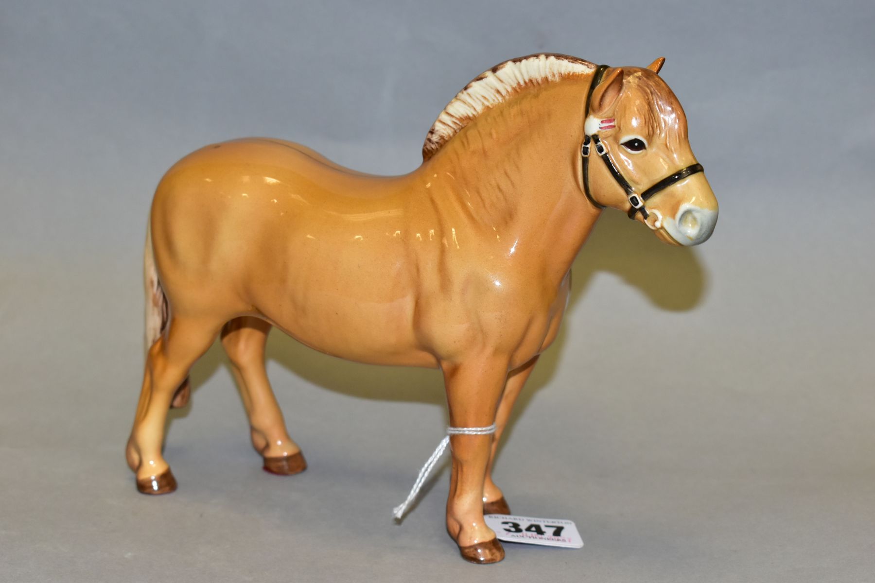 A BESWICK NORWEGIAN FJORD HORSE, model no 2282, dun gloss, printed mark to the underside, adhesive