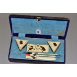 A VINTAGE ORIENTAL CALIGRAPHY SET, constructed with faux ivory decorated with inscribed and