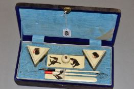 A VINTAGE ORIENTAL CALIGRAPHY SET, constructed with faux ivory decorated with inscribed and