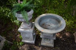 A GREY COMPOSITE GARDEN URN, on a separate plinth, diameter 56cm x height 68cm x height of plinth