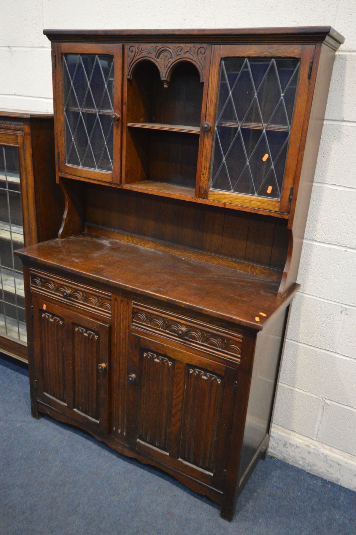 AN EARLY 20TH OAK LEAD GLAZED BOOKCASE, the double doors enclosing three adjustable shelves, on - Image 2 of 3